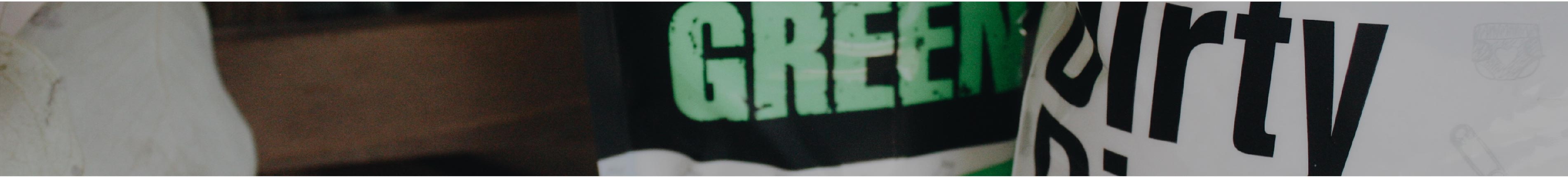 Close-up of two laundry baskets labeled GREEN and Dirty in large letters.