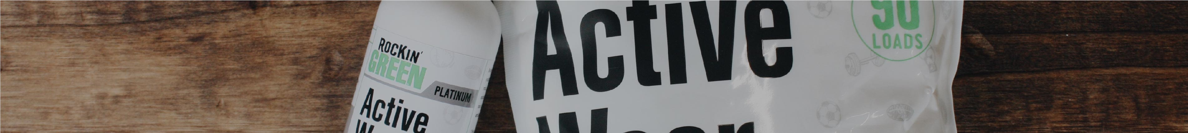 Close-up of two white packages labeled Active Wear against a wooden background.