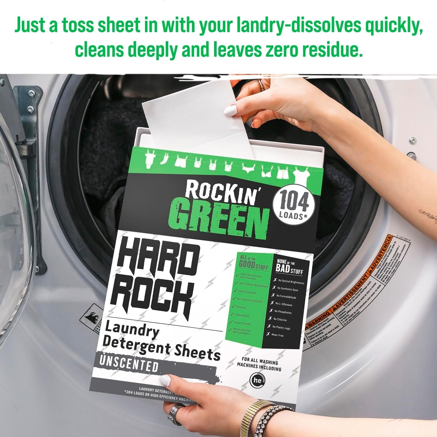 Hands placing Hard Rock Travel Laundry Detergent Sheets for Hard Water into a washing machine.