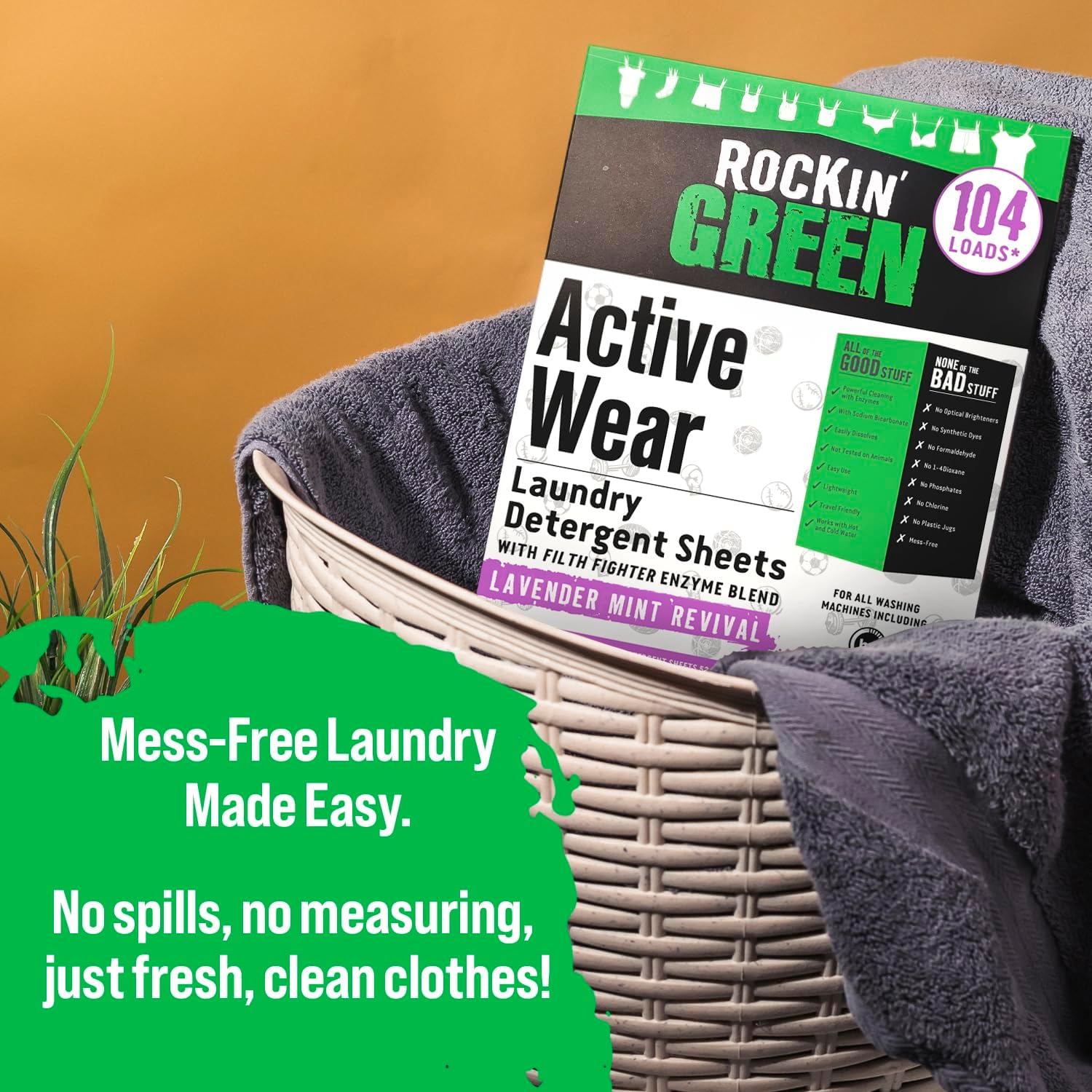 A box of Rockin Green Active Wear Detergent Sheets sits in a basket with dark towels on yellow.