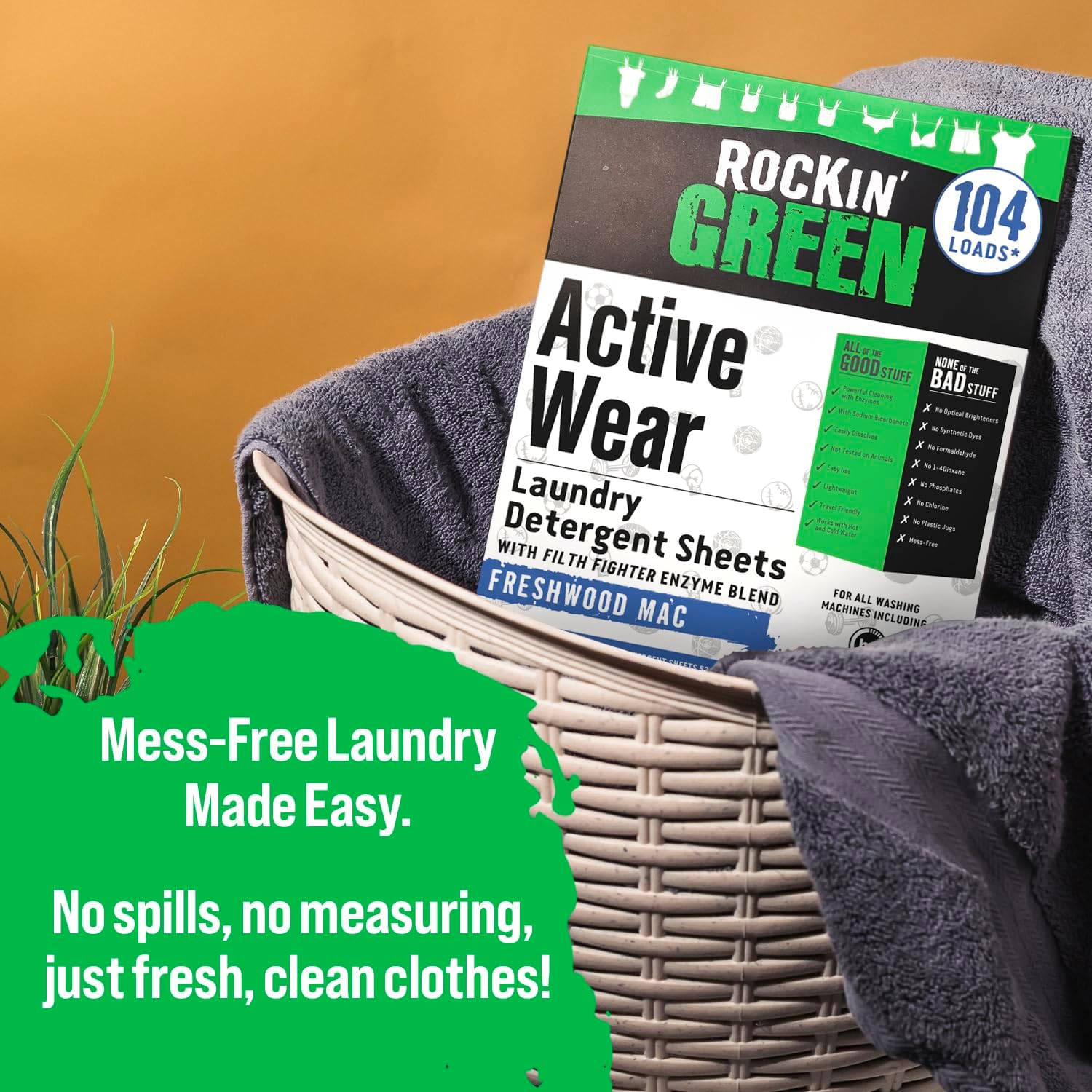 A box of Rockin Green Active Wear Laundry Detergent Sheets Freshwood Mac in a laundry basket with towels.