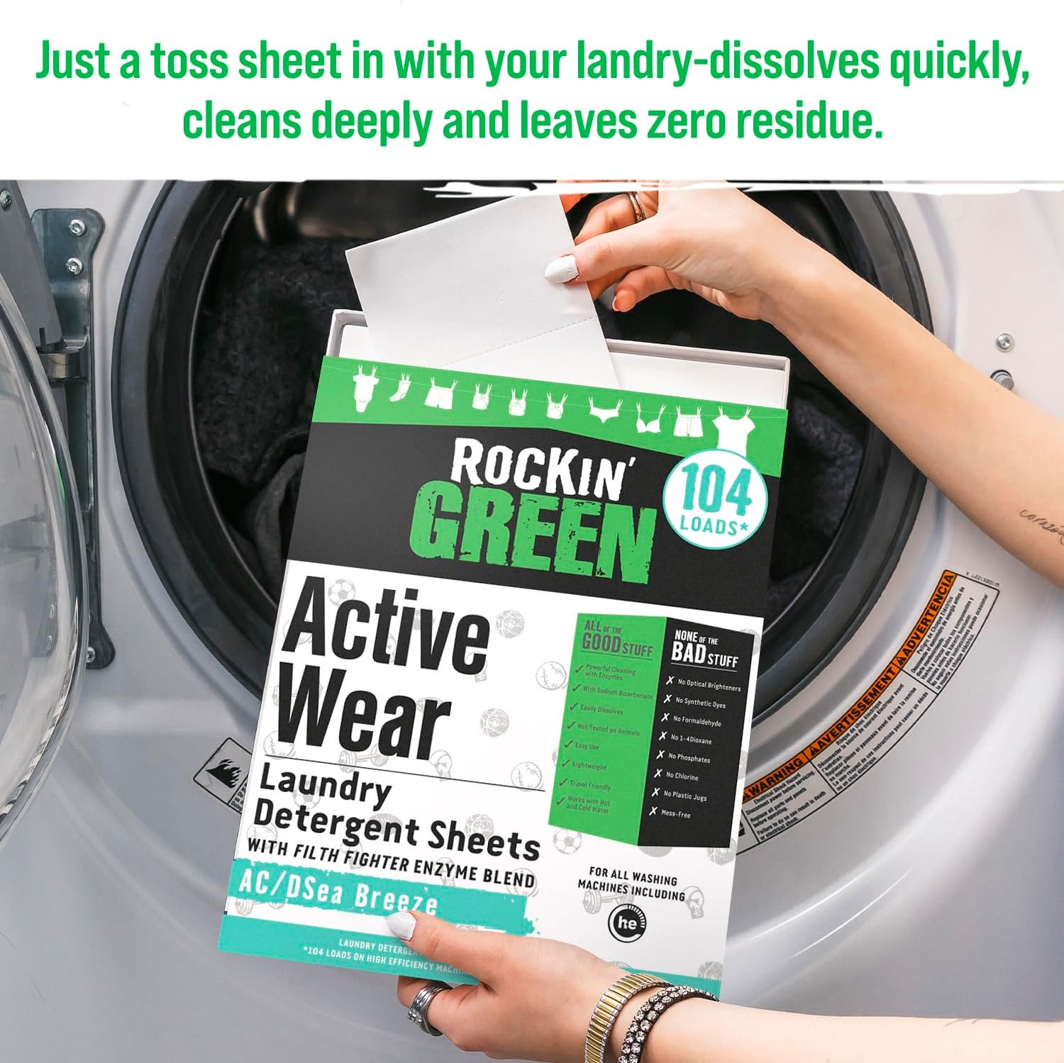 Hand placing Rockin Green Active Wear Laundry Detergent Sheet AC/DSea Breeze into washing machine.