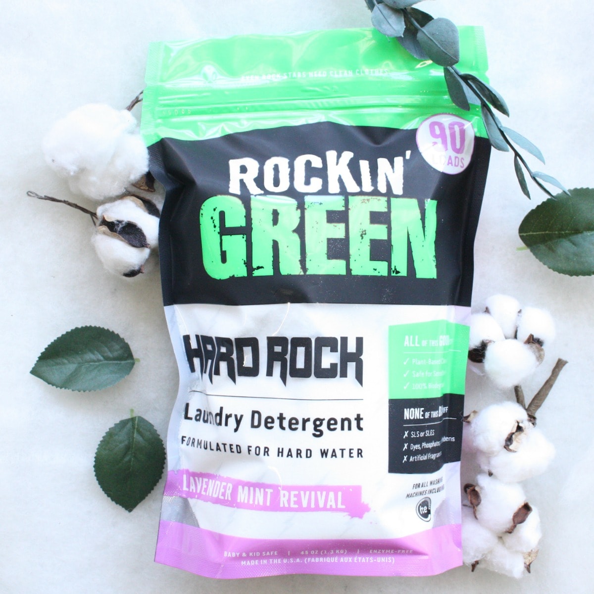 Pack of Hard Rock Laundry Detergent - Lavender Mint Revival with cotton and leaves on a white surface.